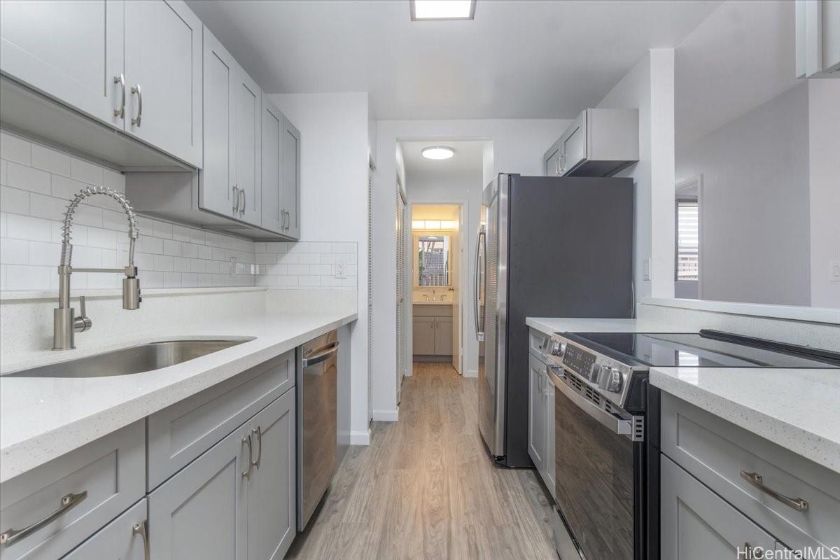 a kitchen with a sink and a refrigerator