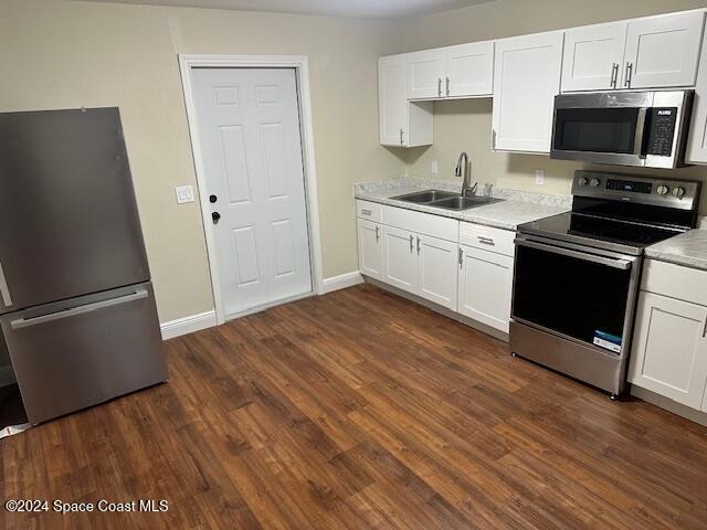 a kitchen with a refrigerator stove and white cabinets