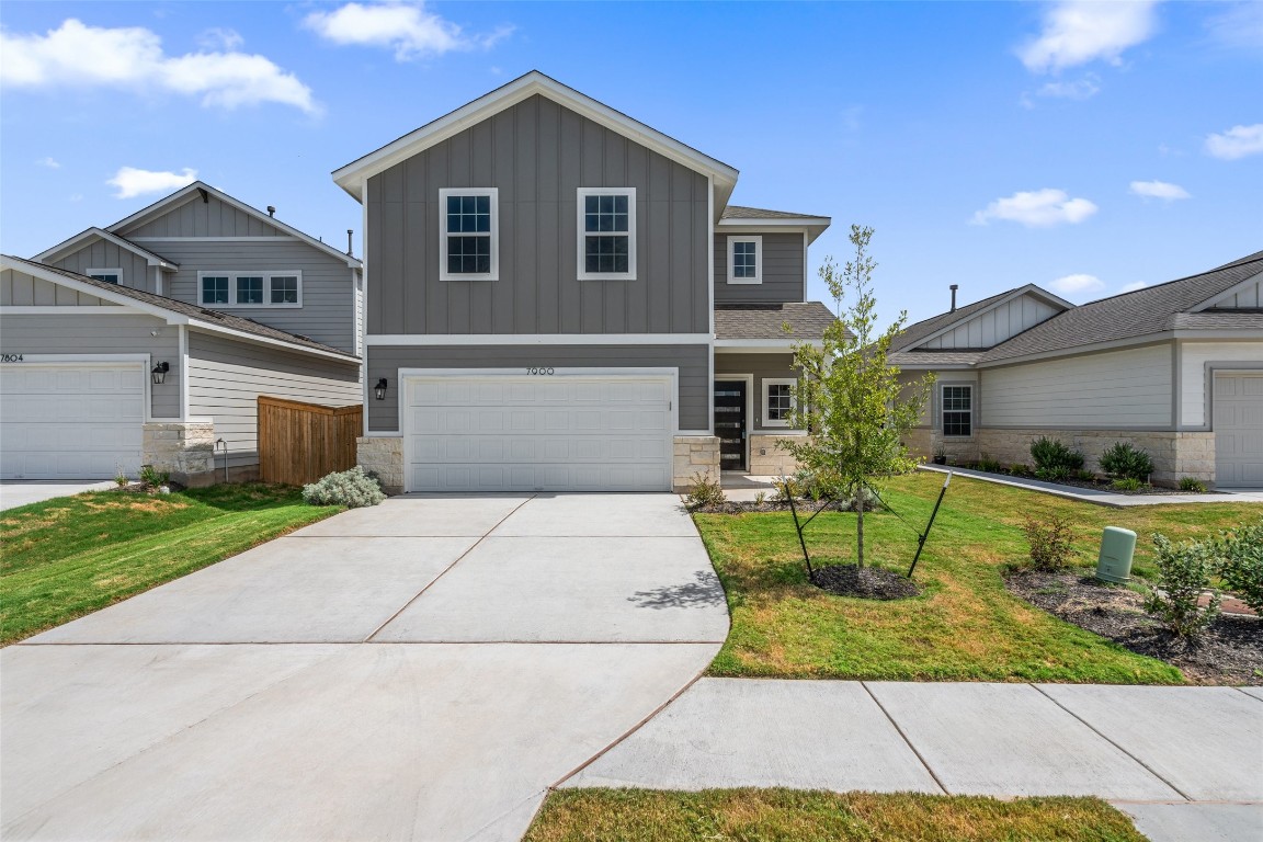 a front view of house with garage and yard