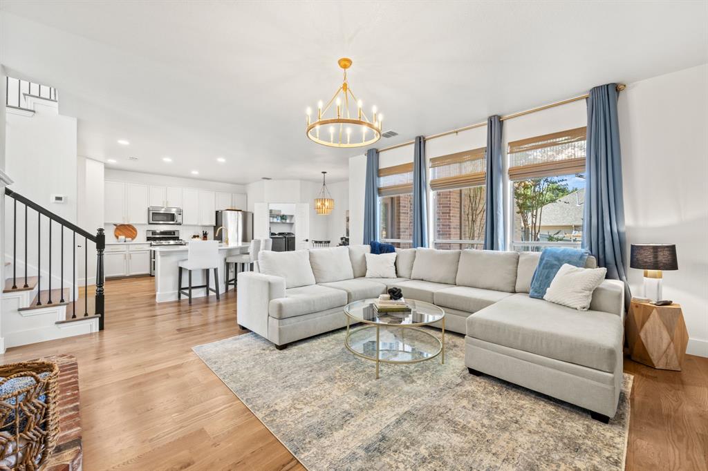 a living room with furniture and a chandelier