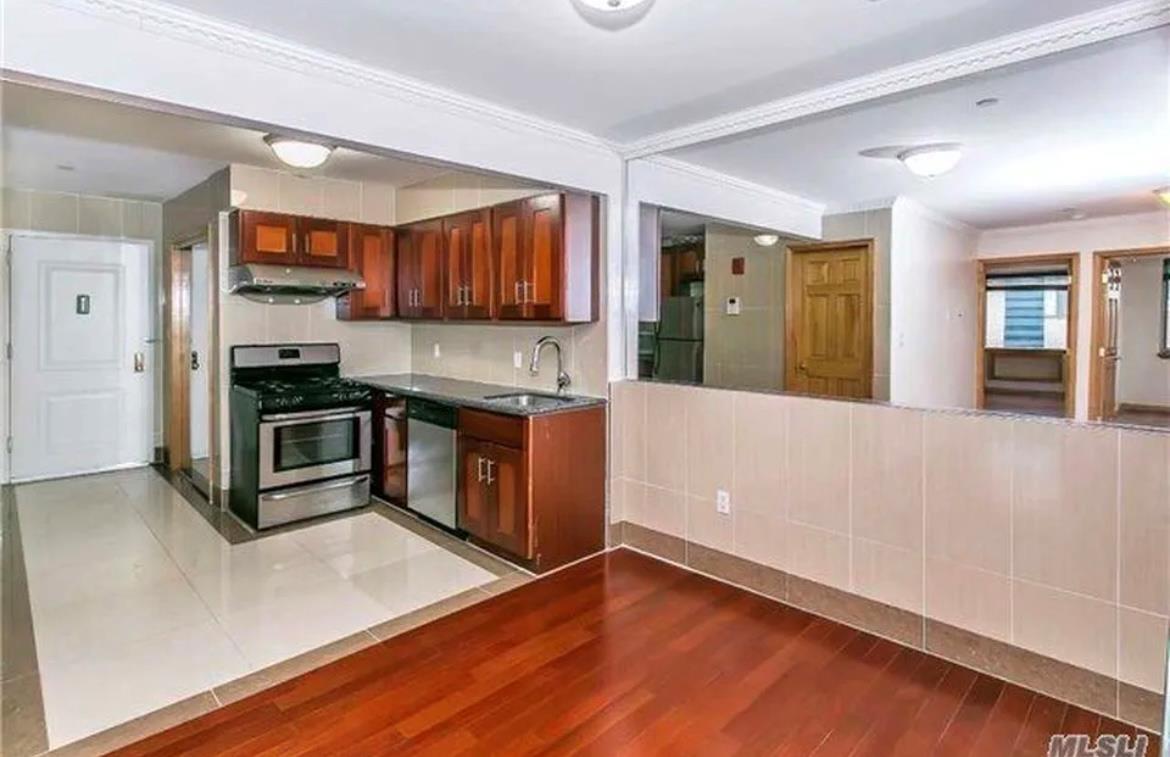 Kitchen featuring appliances with stainless steel finishes, ornamental molding, ventilation hood, sink, and dark hardwood / wood-style floors