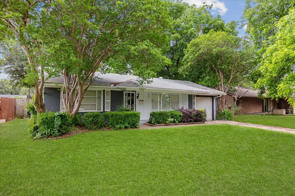 a front view of a house with a yard and porch