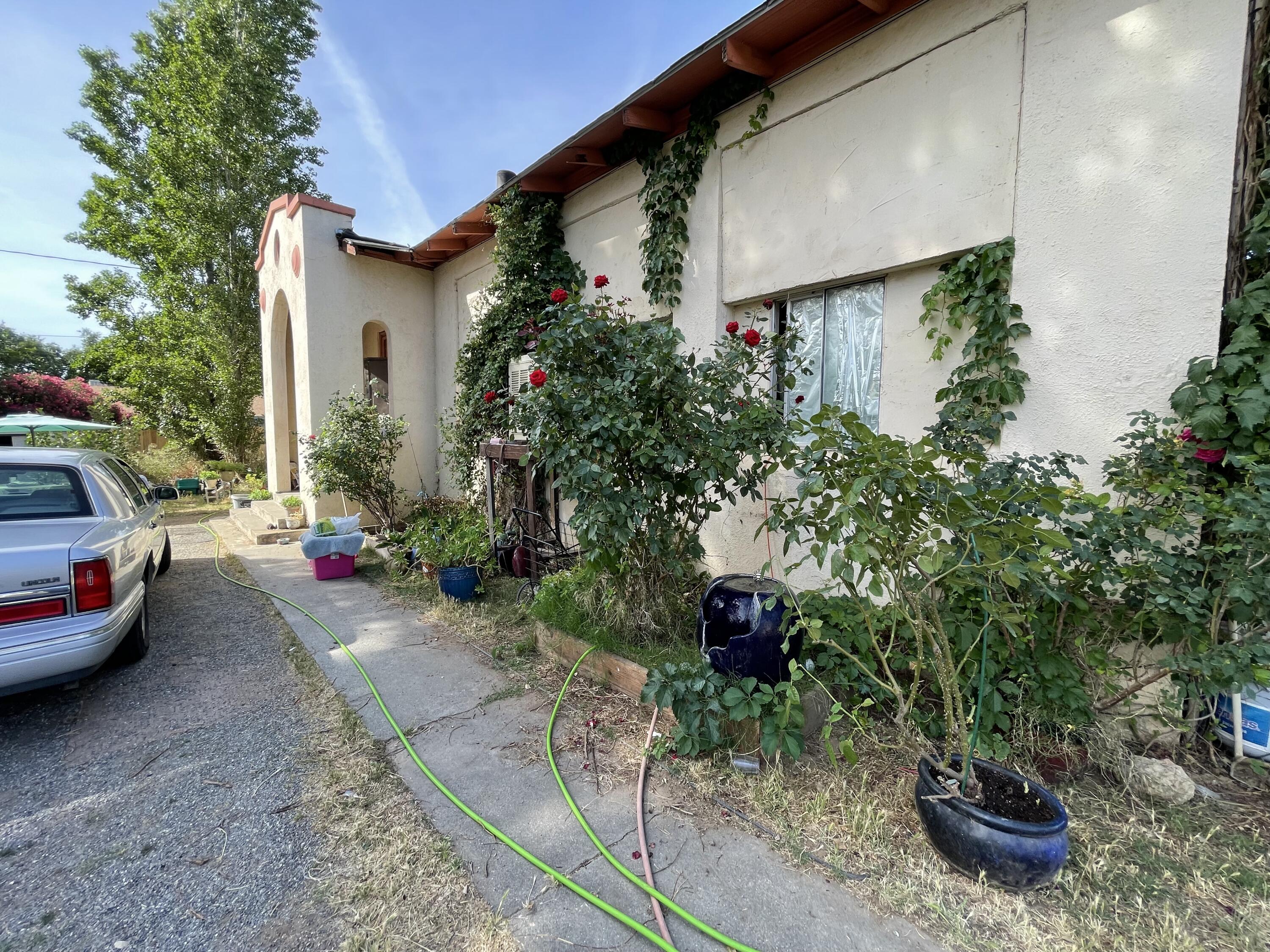 a view of a house with a yard and sitting area