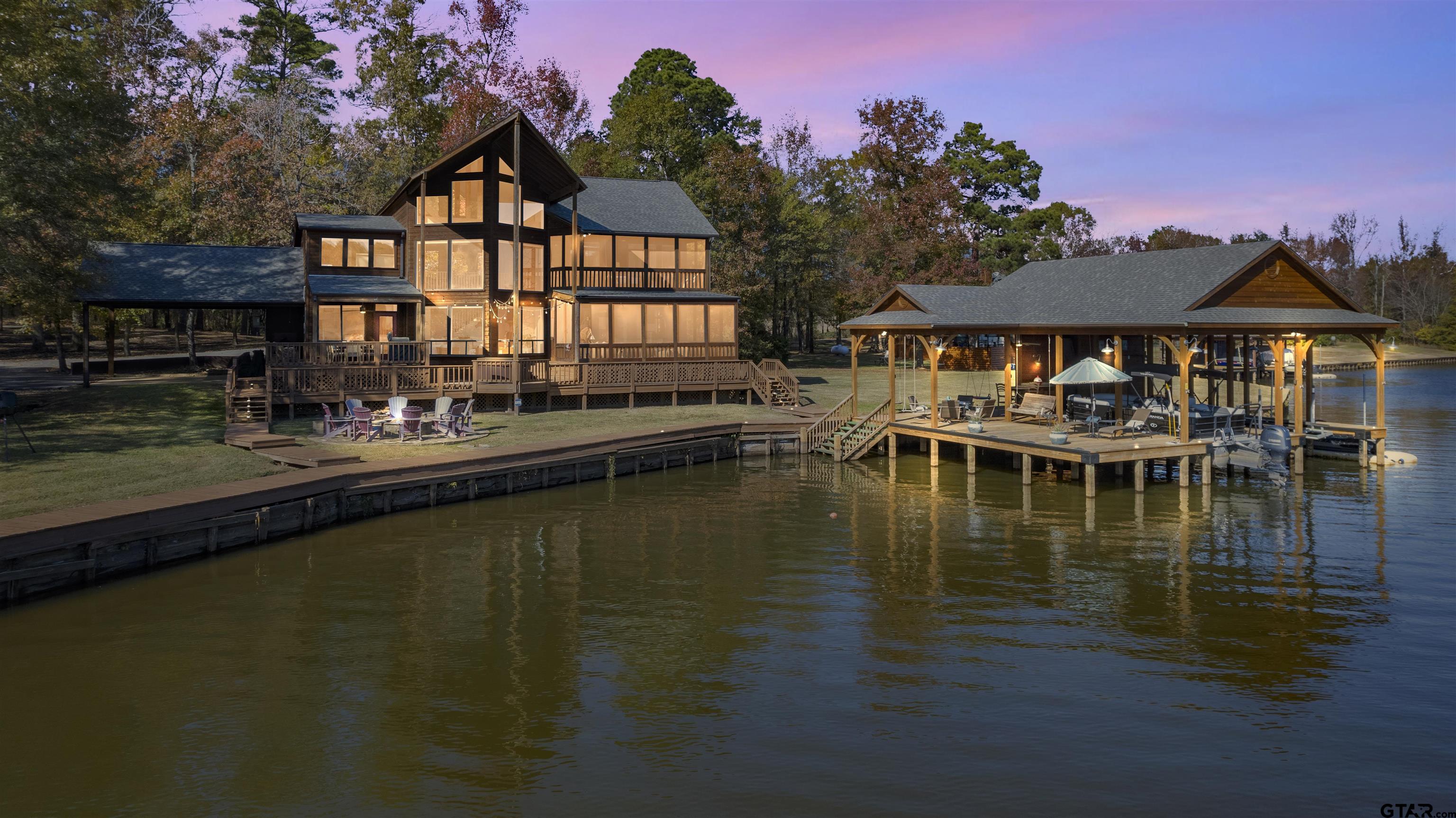 a view of a lake with a house swimming pool and outdoor space