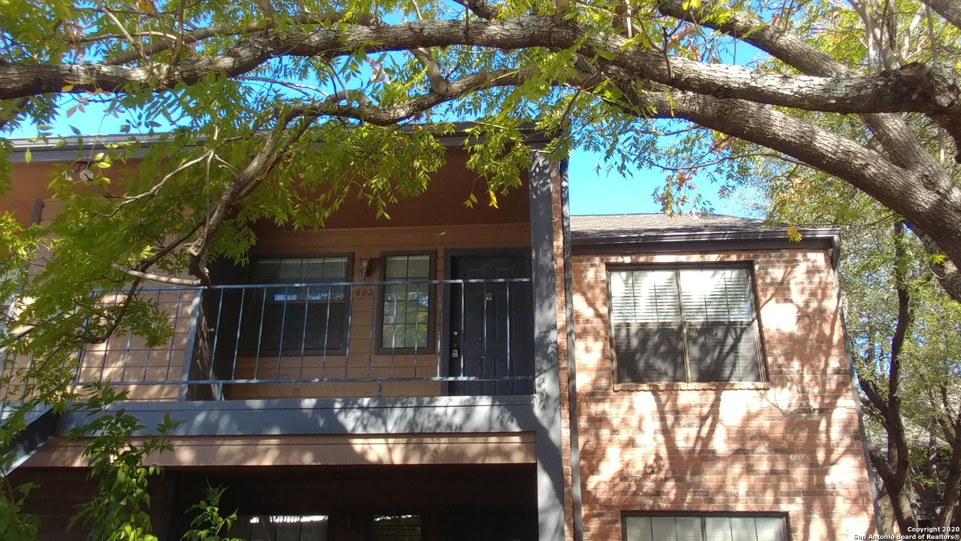 a view of a house with a tree