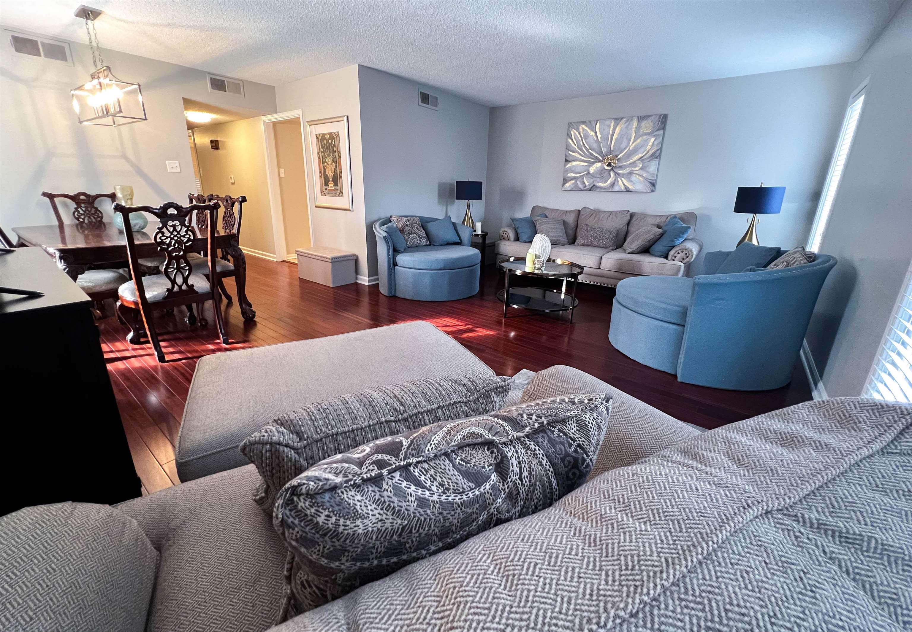 a living room with furniture and wooden floor