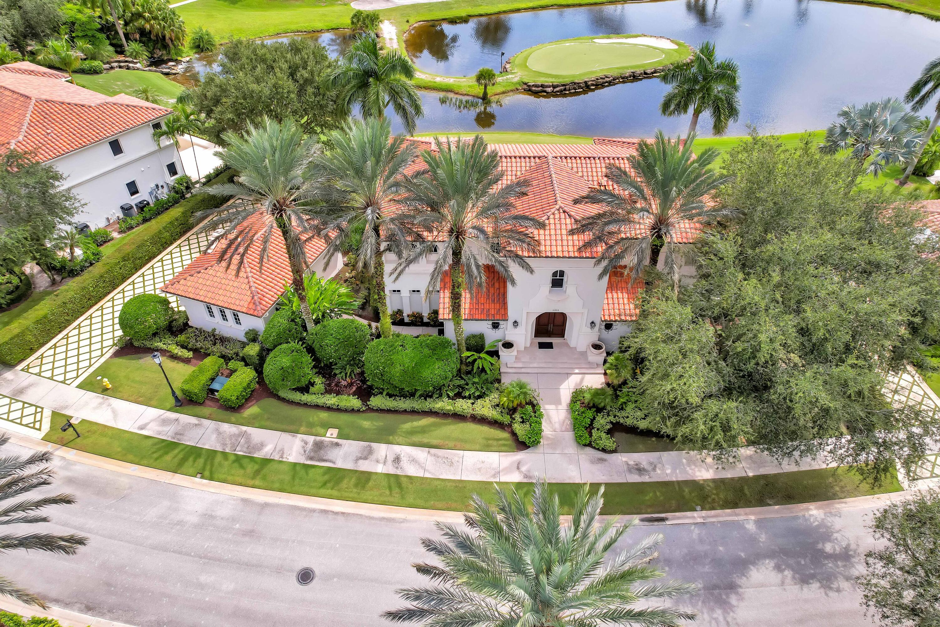 an aerial view of a house with a garden and swimming pool