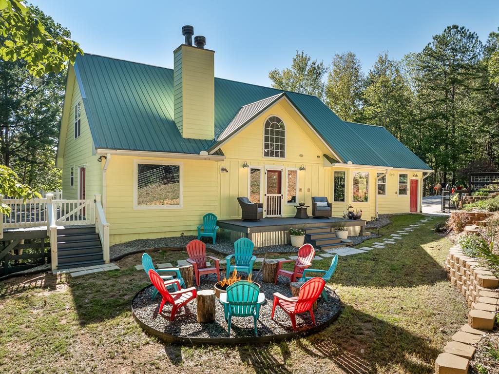 a view of a chairs and tables in backyard of the house