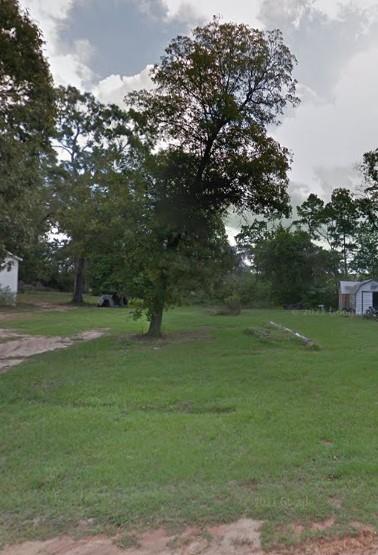 a view of outdoor space with green field and trees