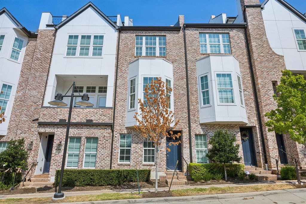 a front view of a residential apartment building with a yard