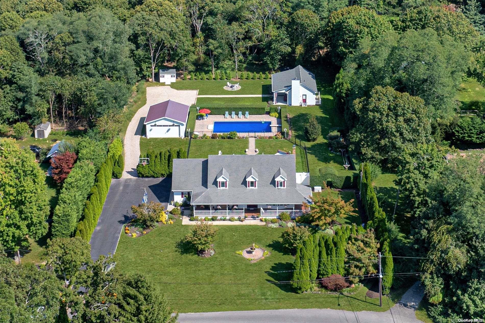 an aerial view of a house with a yard and garden