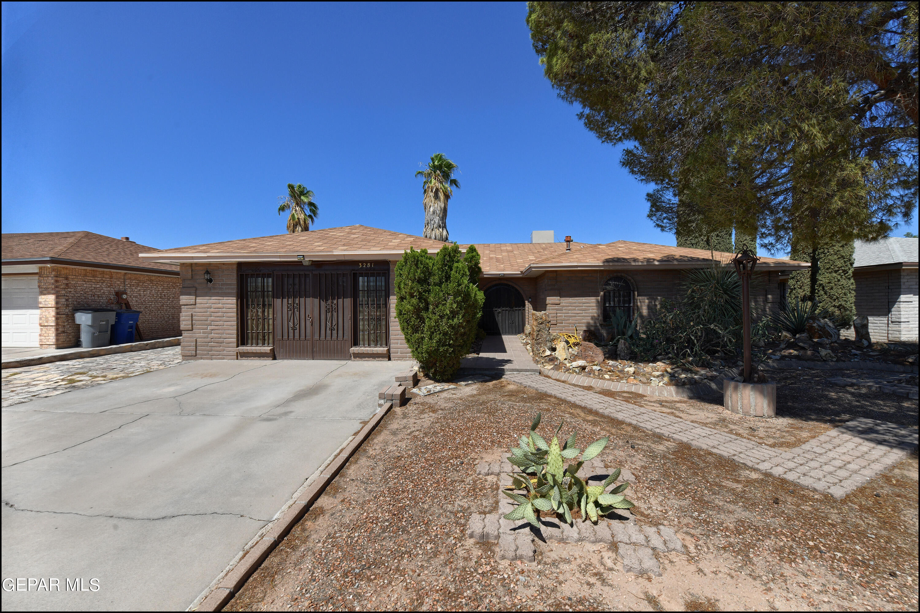 a front view of a house with a yard and a garage