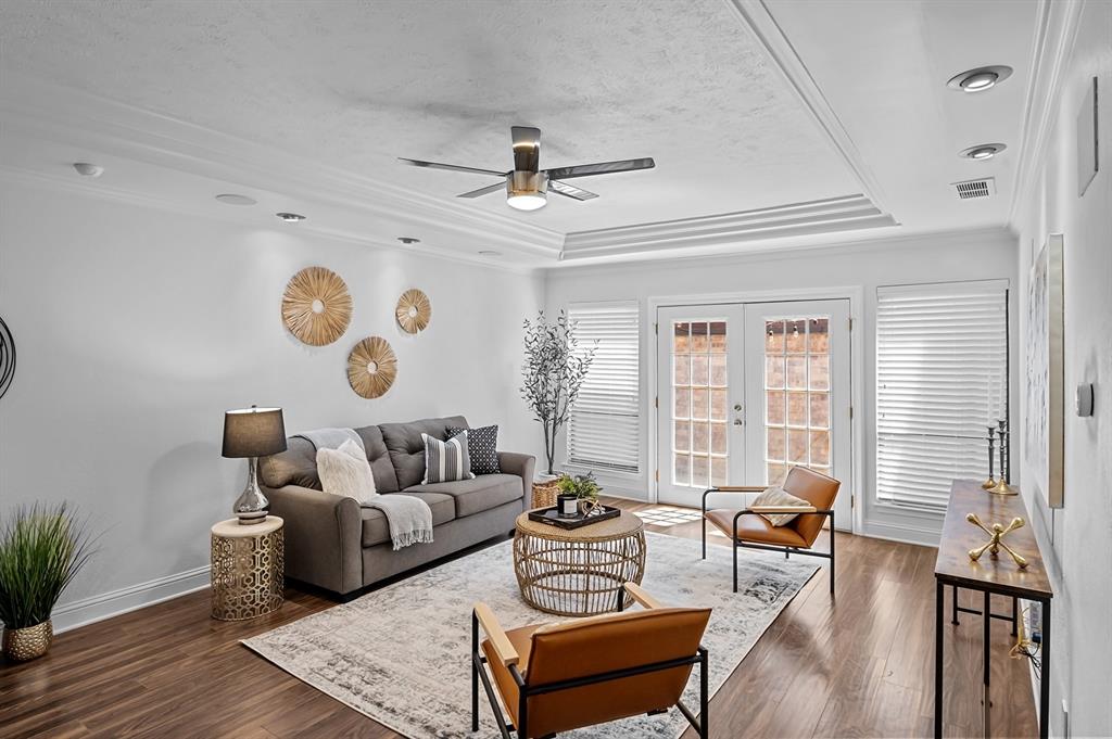 a living room with furniture and wooden floor