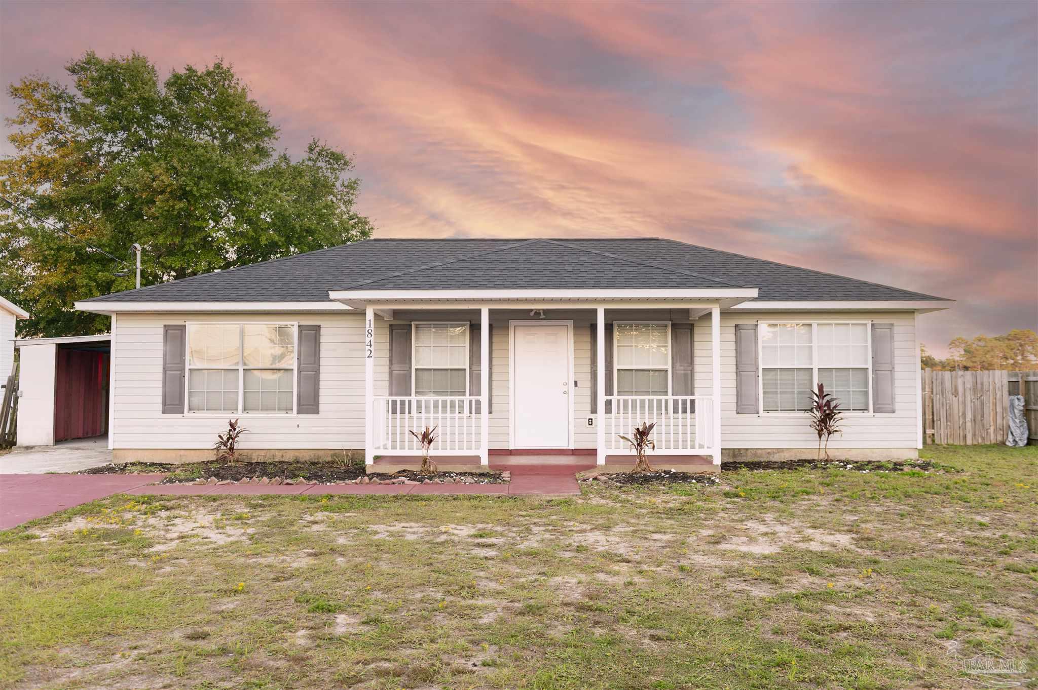 a front view of house with yard and outdoor seating