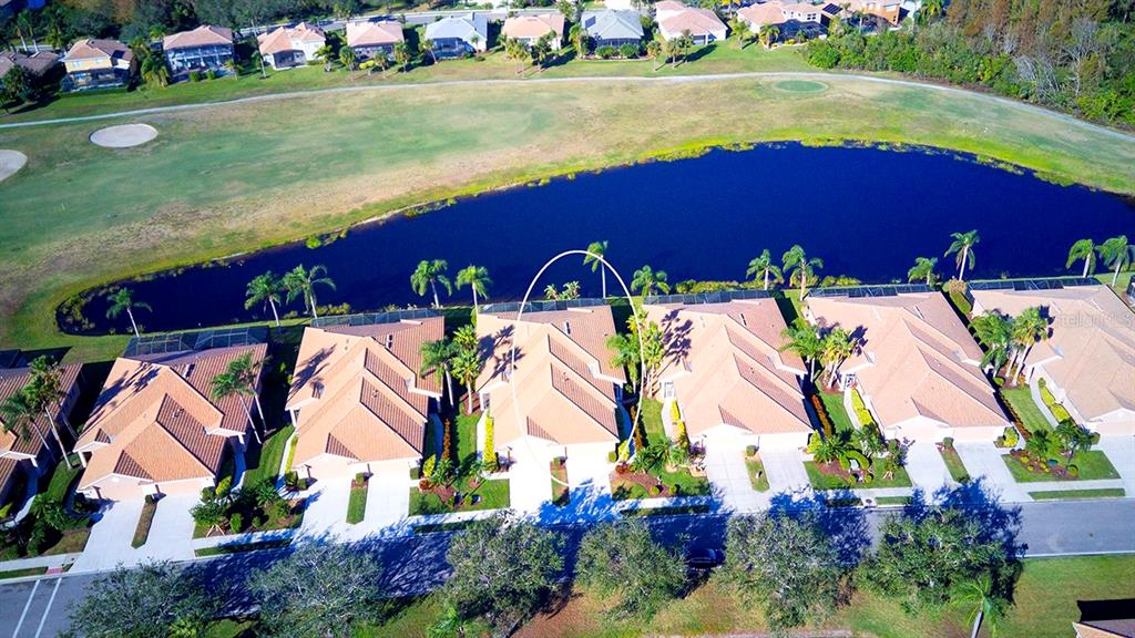 an aerial view of residential houses with outdoor space and swimming pool