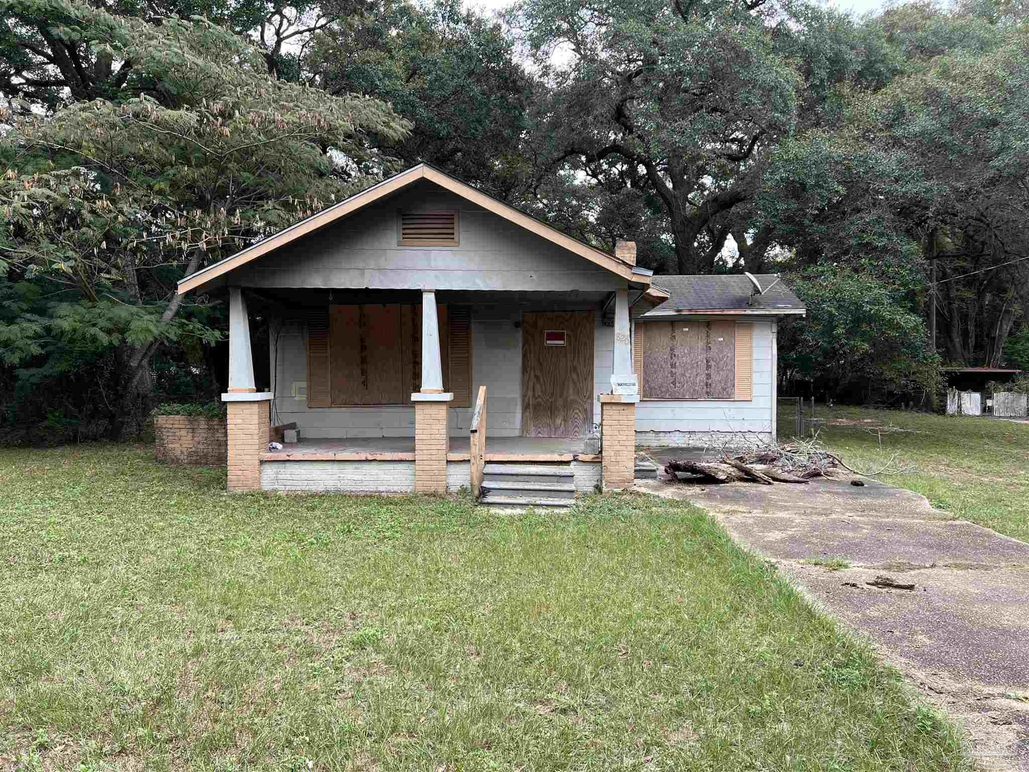 a front view of house with yard and outdoor seating