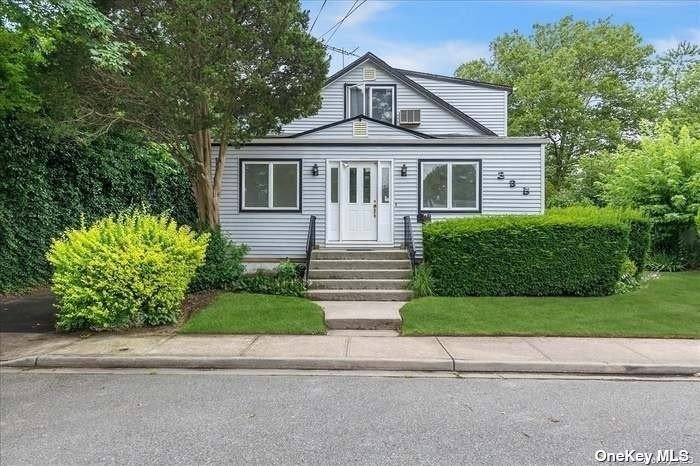 a front view of a house with a yard and a garage