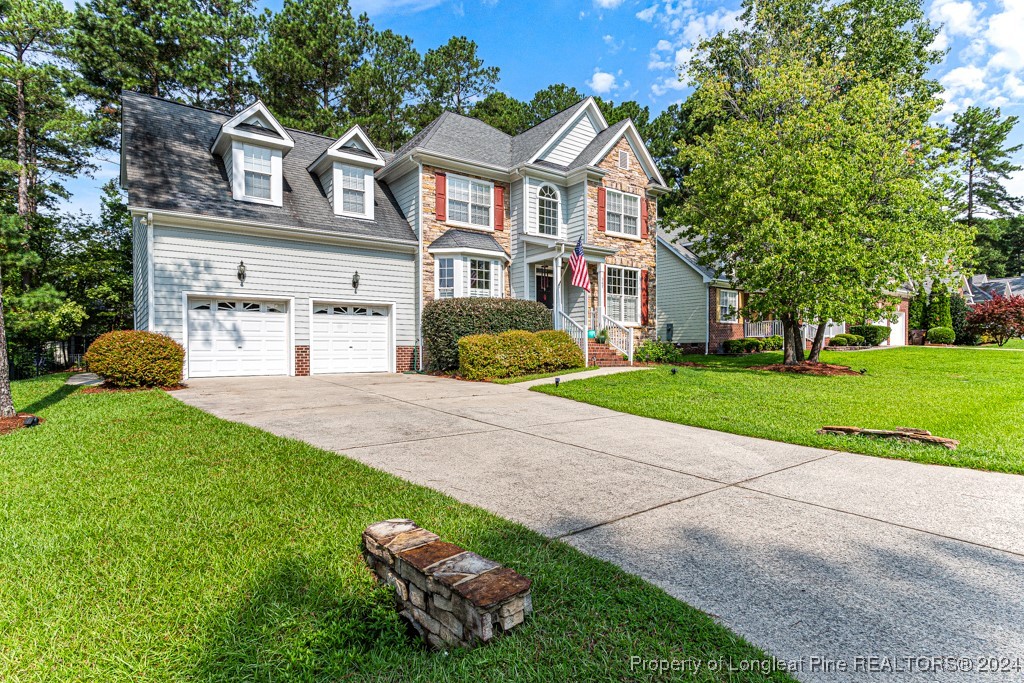 a front view of a house with a yard and garage