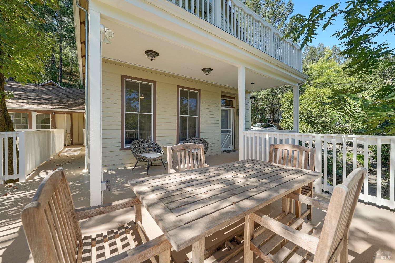 a view of a patio with a table chairs and balcony