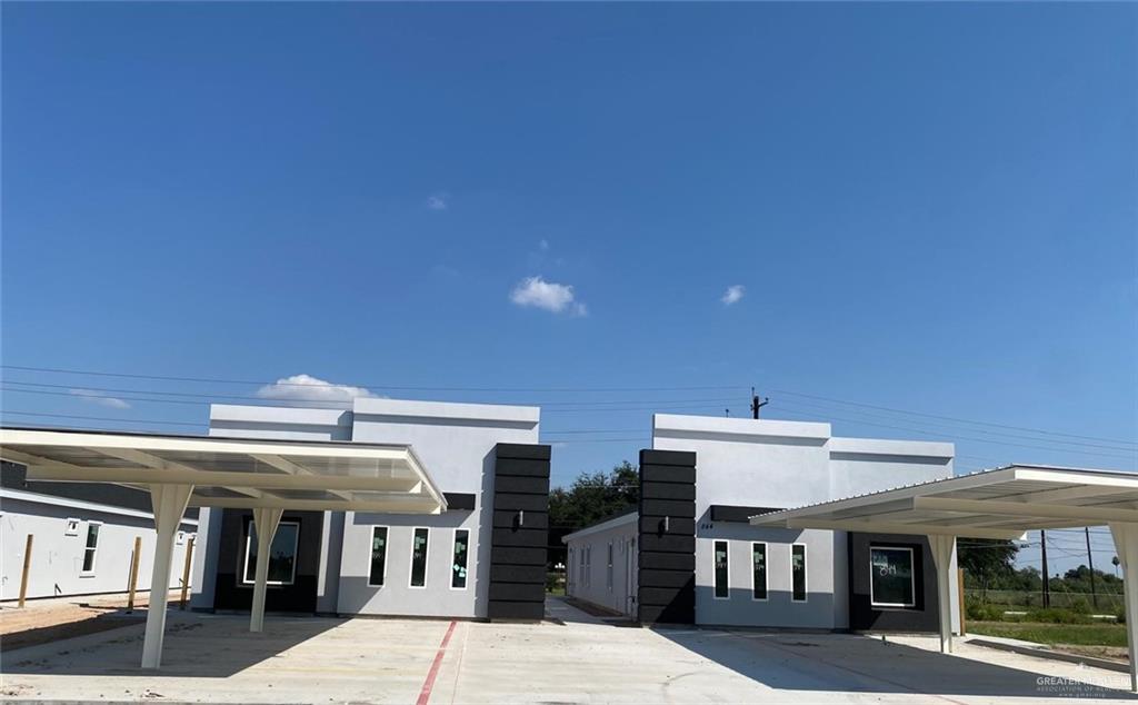 Back of property featuring a carport