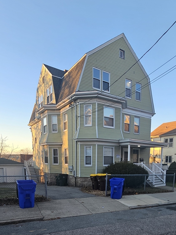 a front view of a residential apartment building with a yard