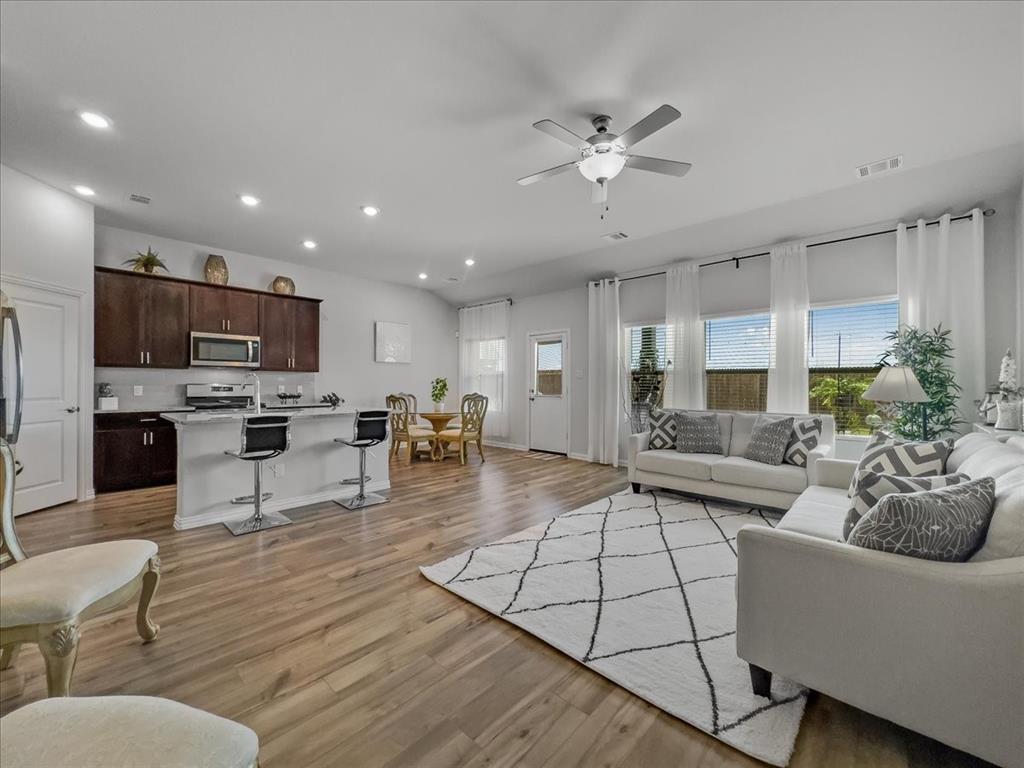 a living room with furniture and kitchen view