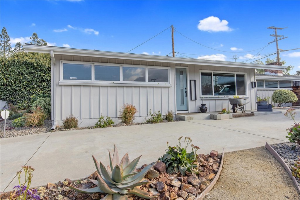 South facing windows provide plenty of natural light, and cheery window boxes are ready for flowers and a touch of spring color. Rain gutters around the edge of roof direct water away from the house.