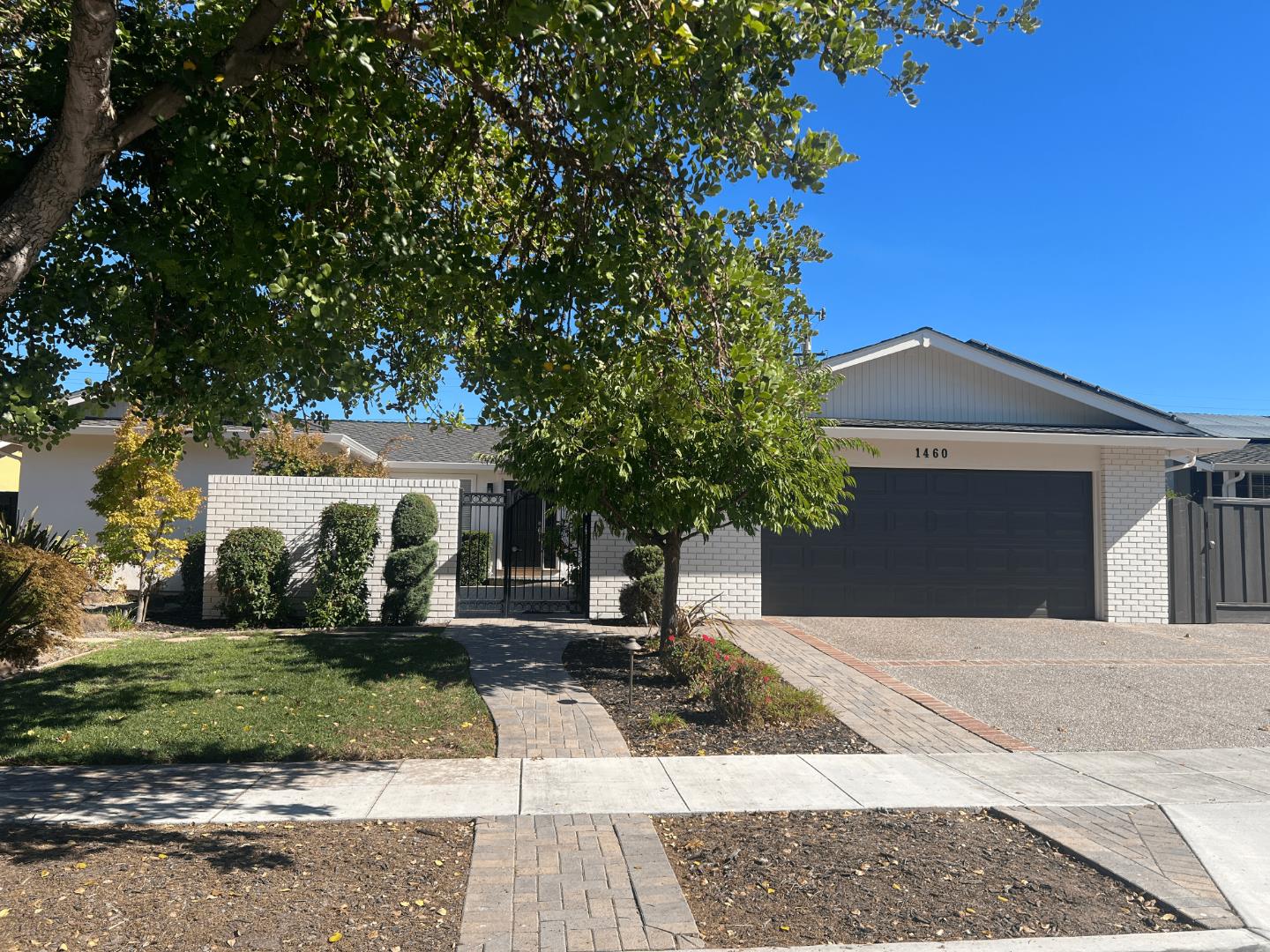 a front view of a house with a yard and a garage