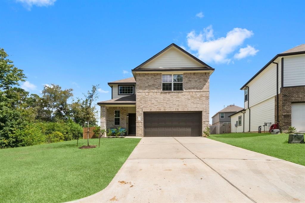 a front view of a house with a yard and garage