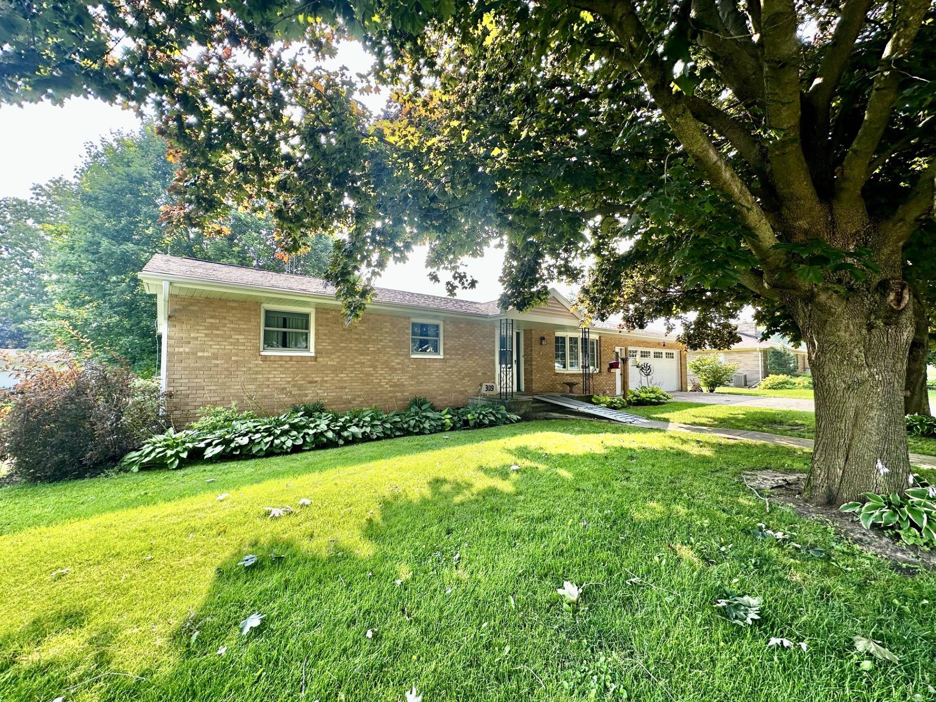 a front view of house with yard and green space