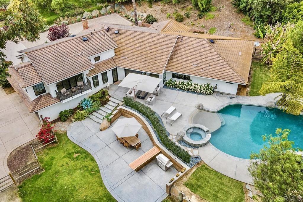 an aerial view of residential house with outdoor space and parking