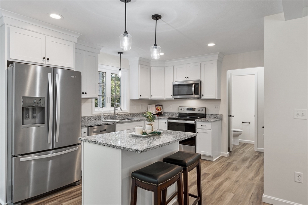 a kitchen with refrigerator a stove a sink and a refrigerator