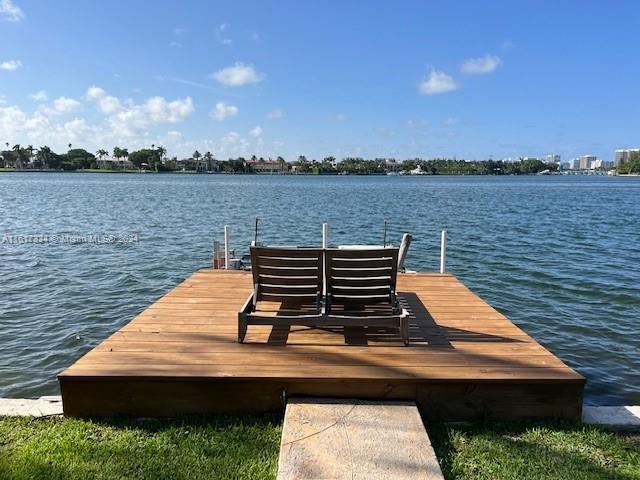 a wooden bench sitting next to a lake