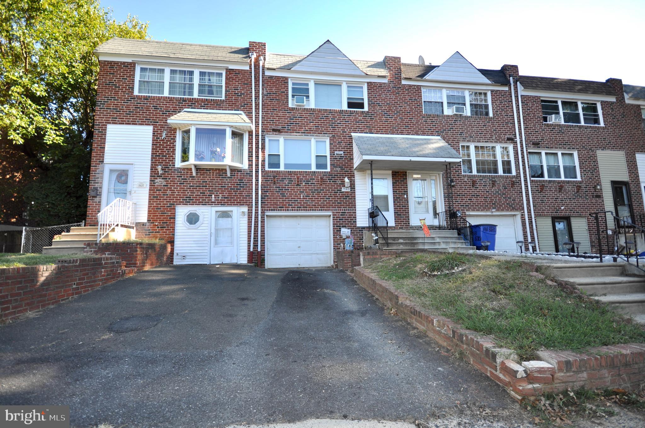 a front view of a residential apartment building with a yard