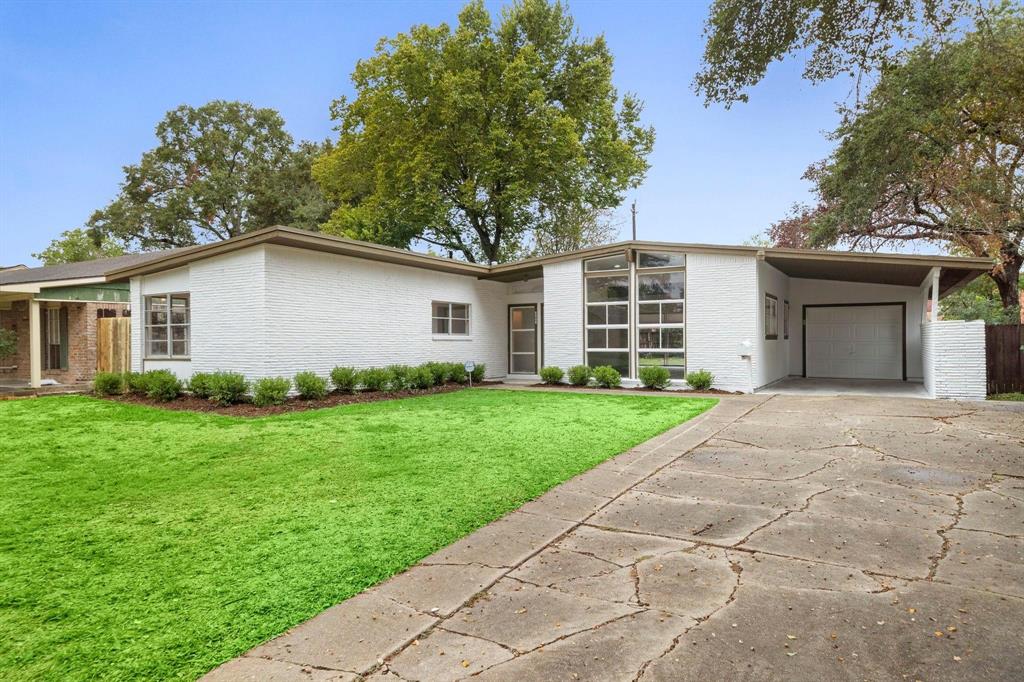 a view of a house with yard and a garden