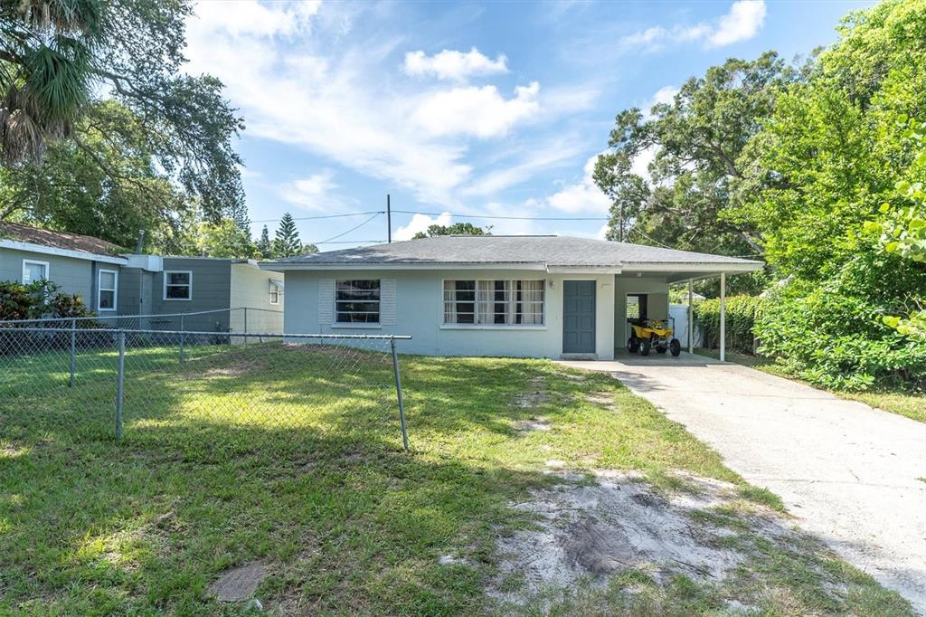 a view of a house with a backyard