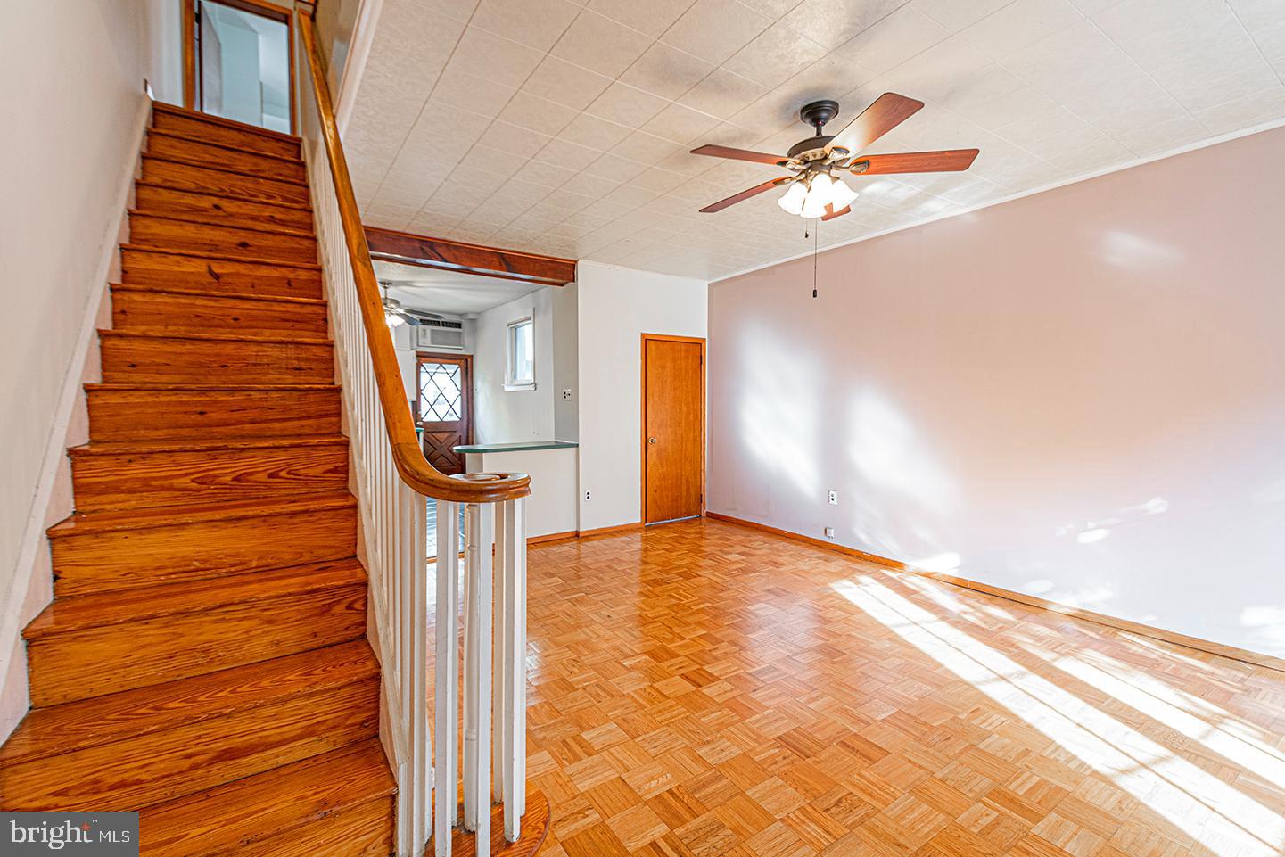 a view of a hallway with a dining table chairs and a chandelier