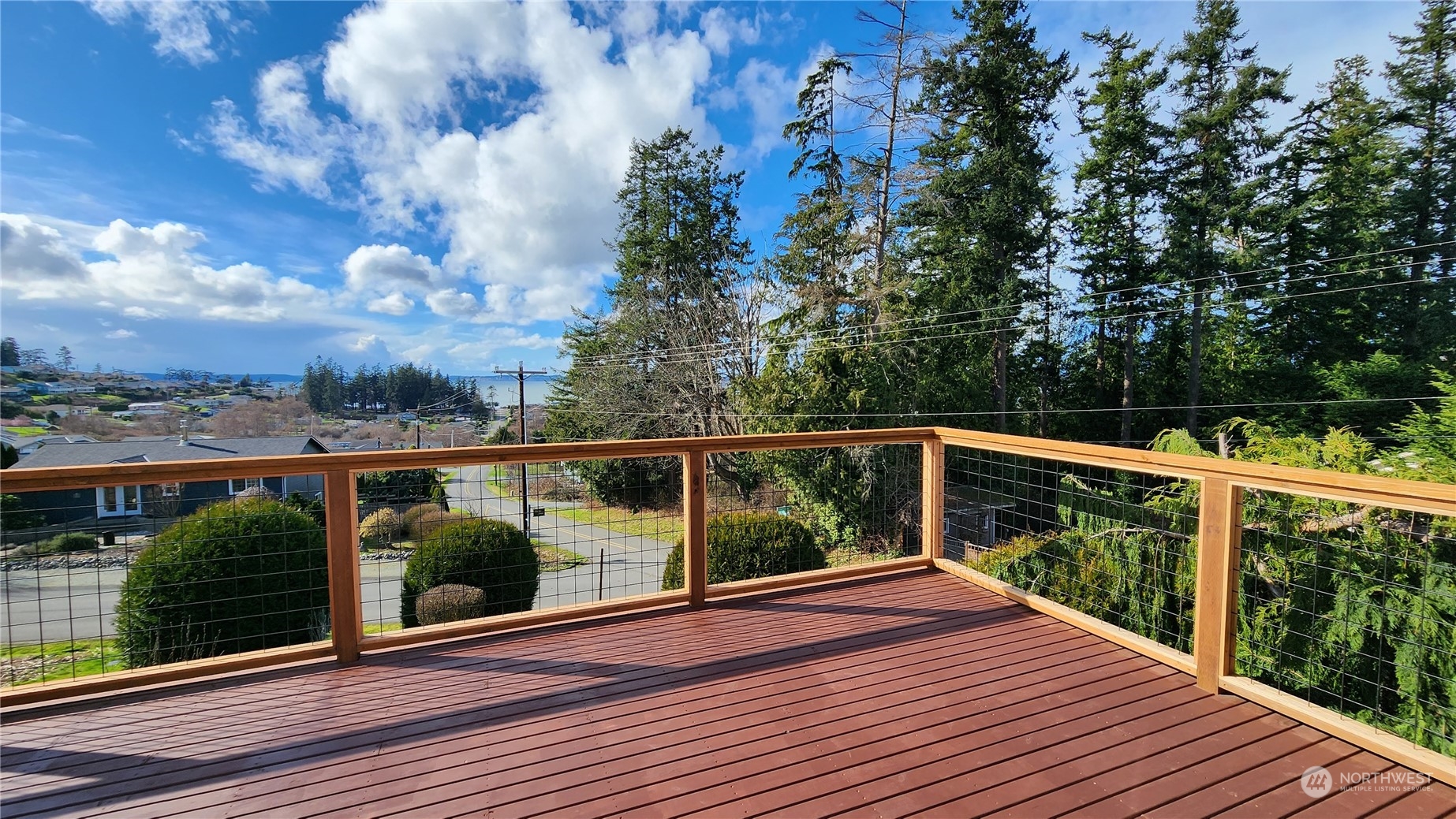 a view of balcony with wooden floor and fence