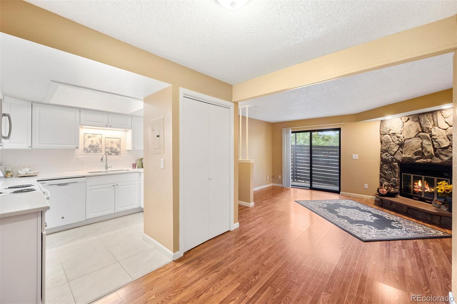 a open kitchen with cabinets and wooden floor