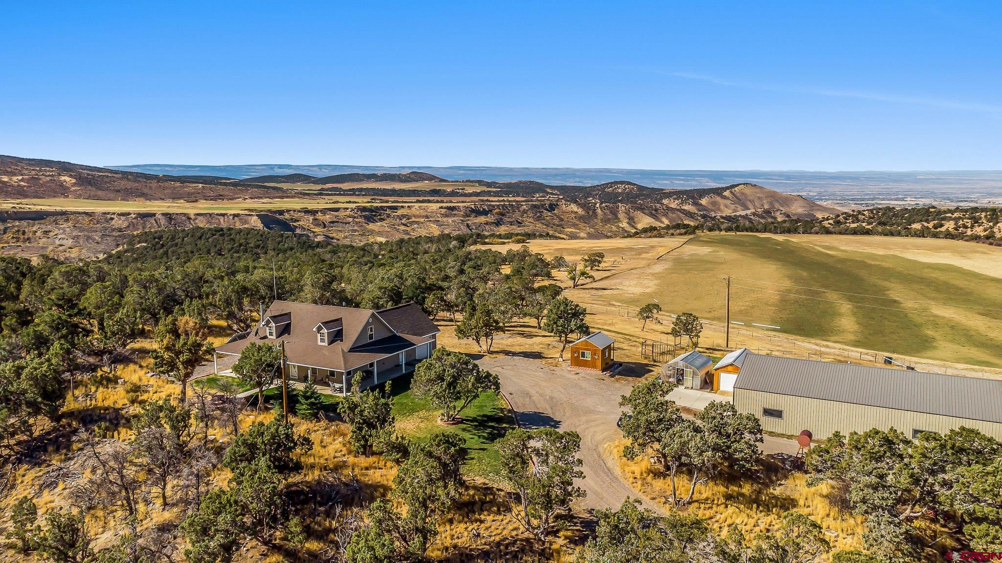 an aerial view of a house with a lake view