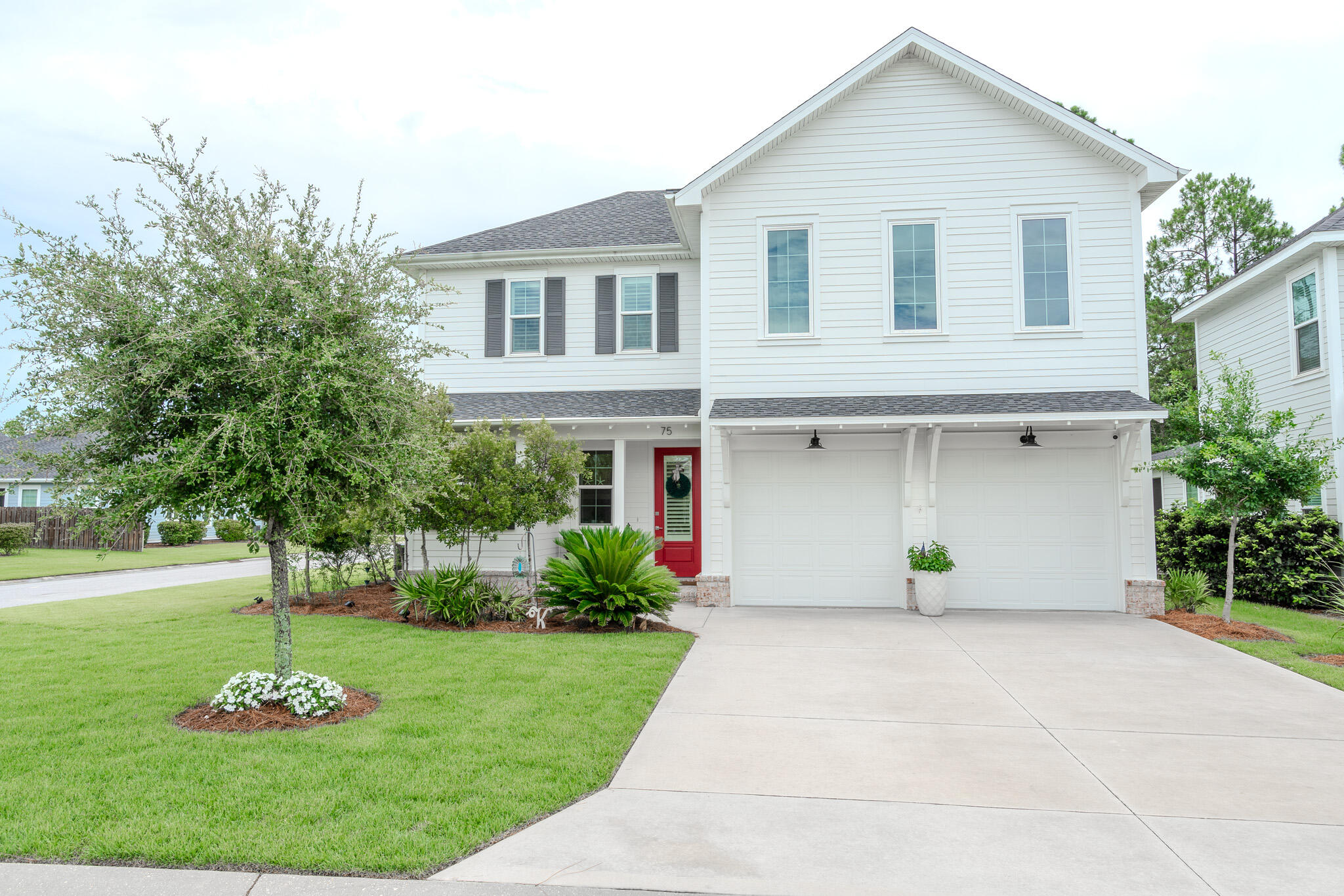 a front view of a house with a garden