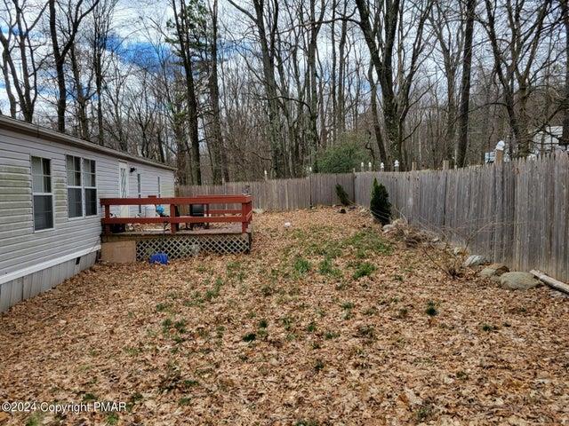 a backyard of a house with oven and wooden fence