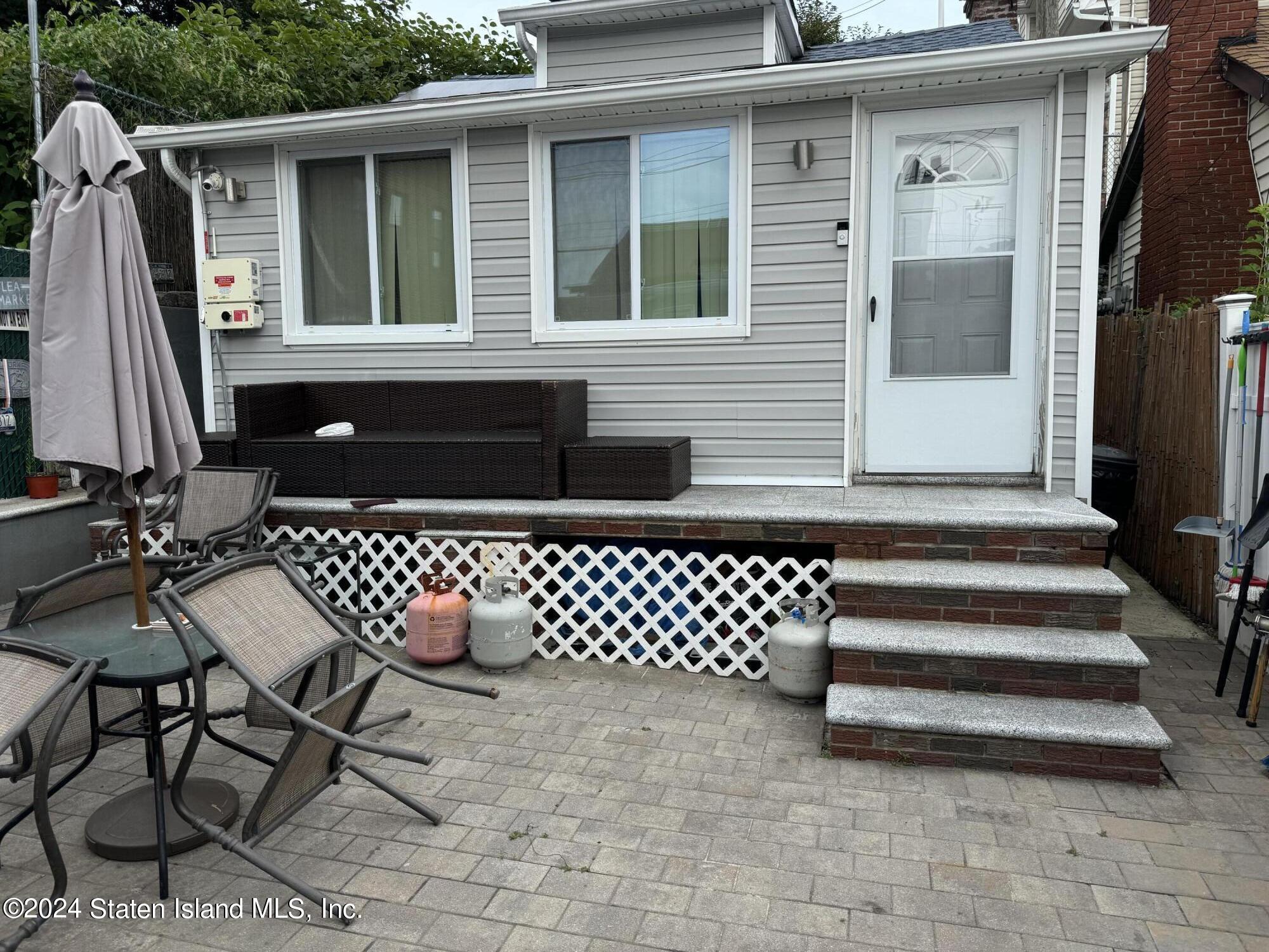 a front view of a house with a bench