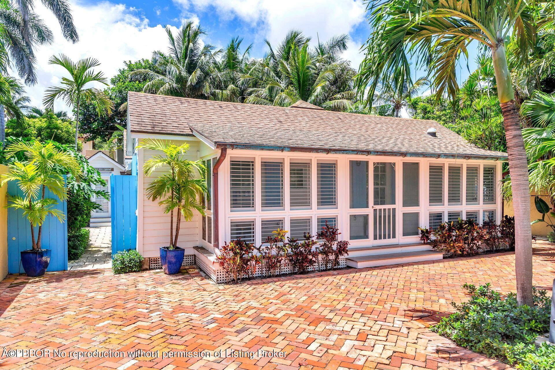 a front view of a house with a garden and patio