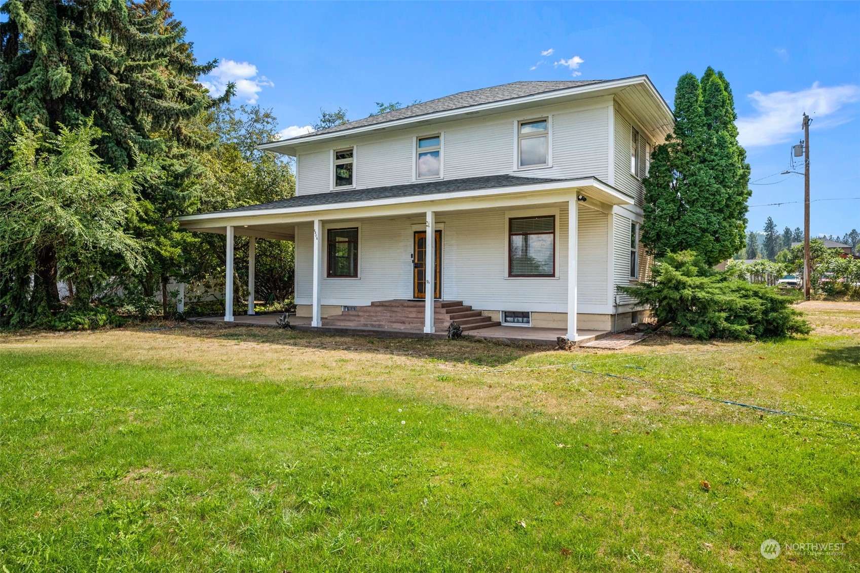 a front view of house with yard and green space