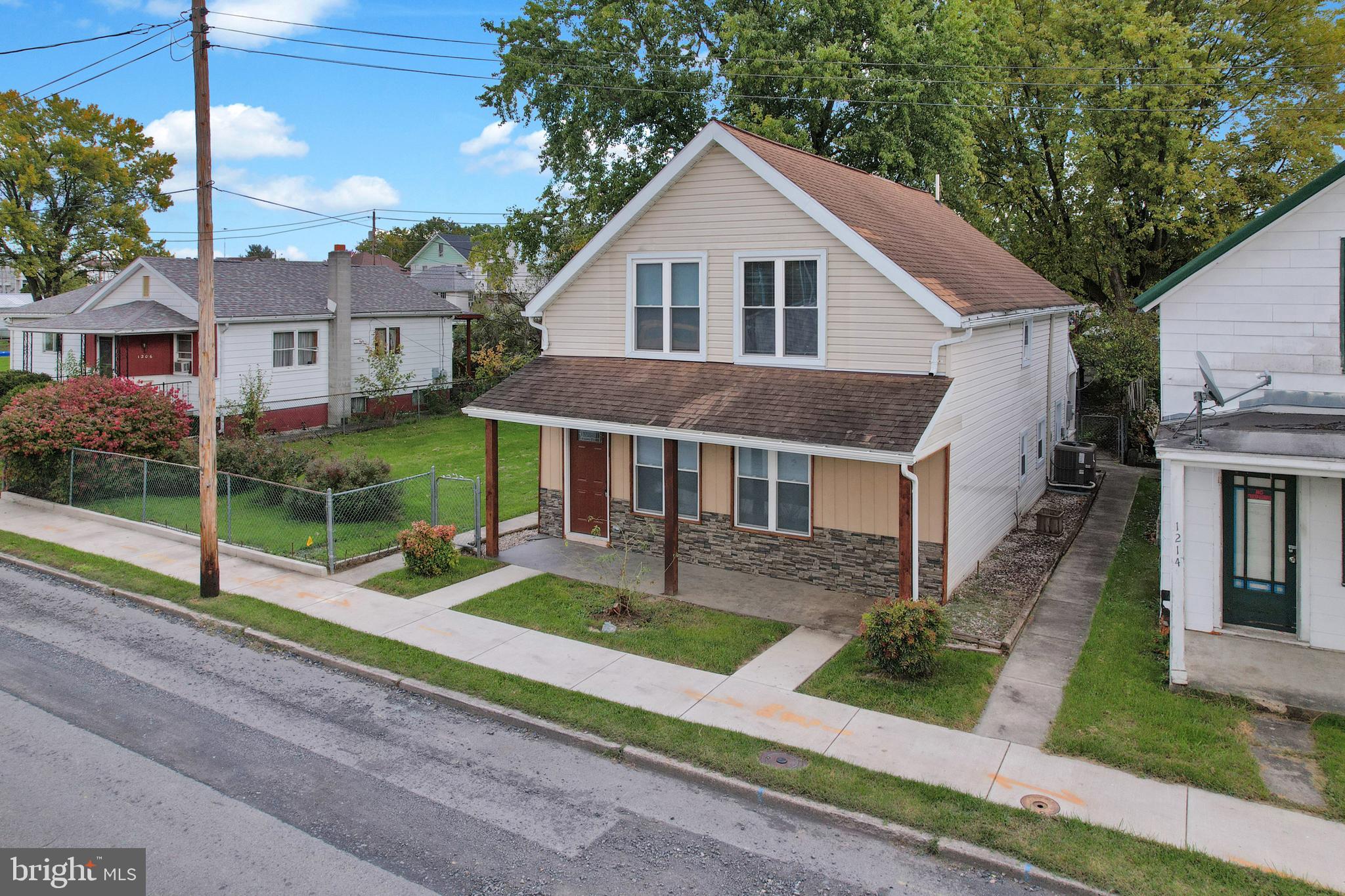 a front view of a house with a yard and porch