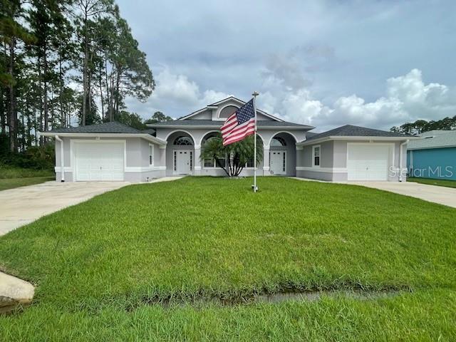 a front view of house with a garden