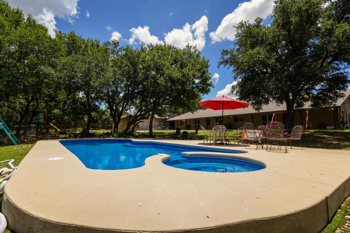 a view of a swimming pool with a yard