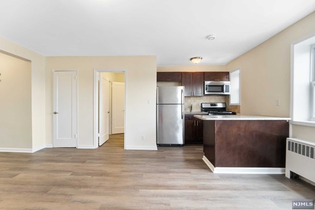 a kitchen with stainless steel appliances a refrigerator and a stove top oven