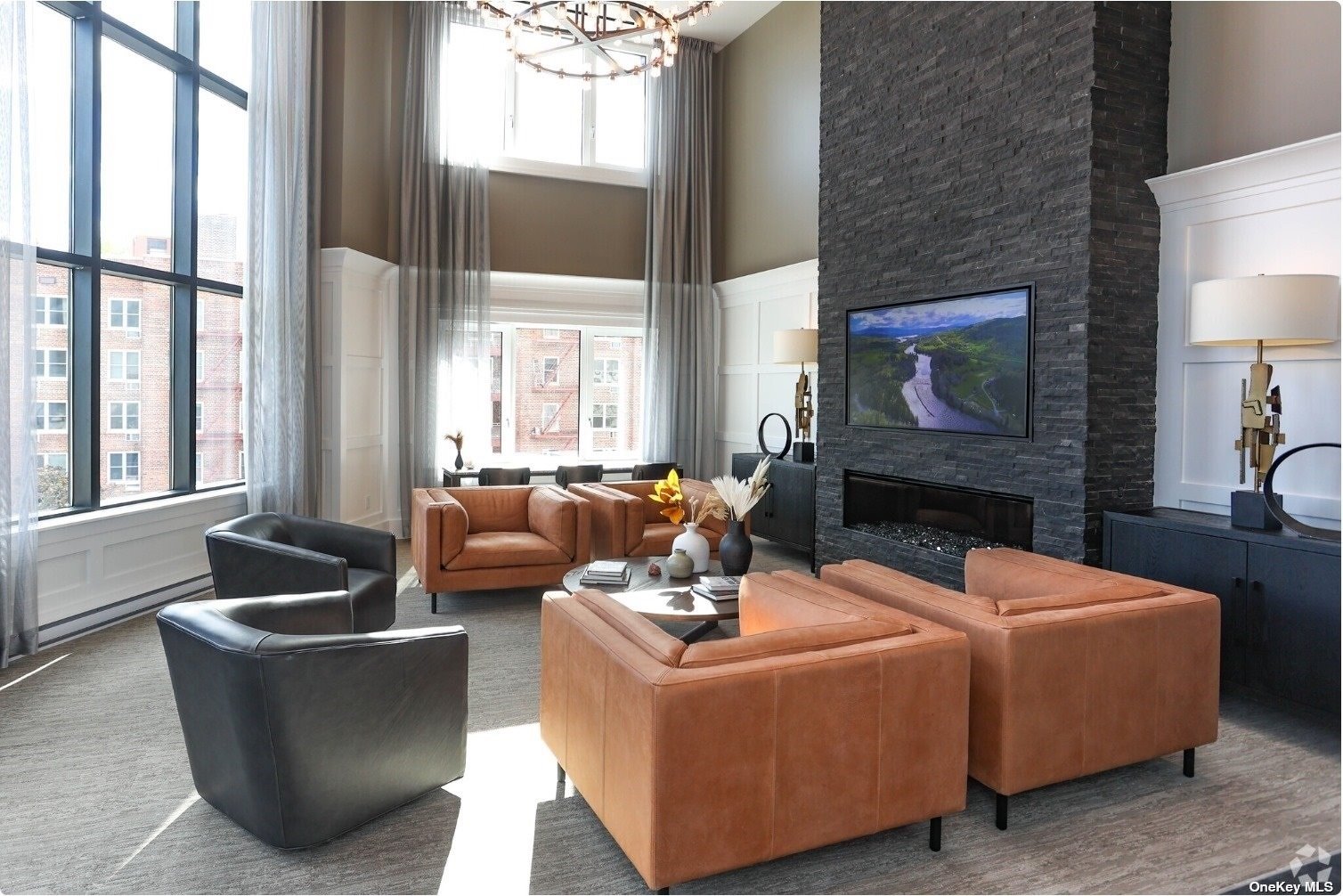 a living room with fireplace furniture and a large window